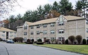 Clinton apartment for rent - a large brick building with a car parked in front of it