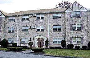 Clinton apartment for rent - a brick apartment building with a yard in front of it