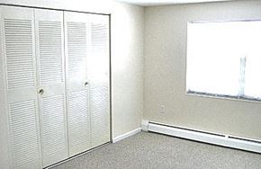 Clinton apartment for rent - an empty room with white doors and a window