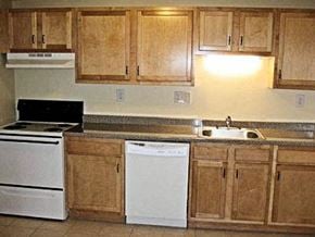 Clinton apartment for rent - a kitchen with white appliances and wooden cabinets