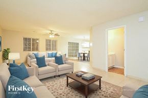 Browns Summit house for rent - A living room with a couch, a coffee table, and a lamp.