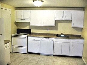 Clinton apartment for rent - a kitchen with white cabinets and a stove and a sink