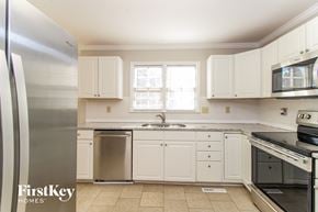 Clemmons house for rent - a white kitchen with stainless steel appliances and white cabinets