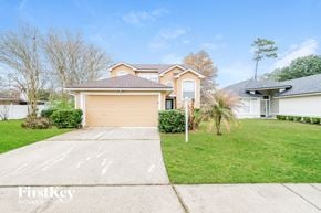 Jacksonville house for rent - a home with a driveway and a garage door