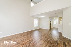 Jacksonville house for rent - the living room and dining room with hardwood floors and white walls