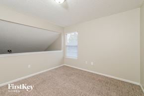 Jacksonville house for rent - a spacious bedroom with carpet and a large mirror