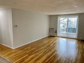 Quincy apartment for rent - Living Room with Hardwood Floors and Slider Door to Balcony