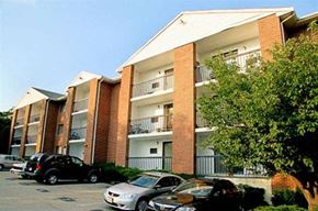 Quincy apartment for rent - an apartment building with cars parked in front of it