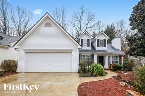 Gainesville house for rent - A white house with a garage is shown in the image.