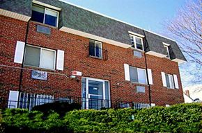 Quincy apartment for rent - a brick apartment building with a blue door