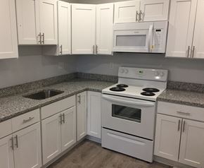 Quincy apartment for rent - Renovated kitchen with granite counters, white cabinets and white appliances