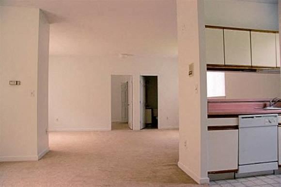 Attleboro apartment for rent - an empty kitchen with white cabinets and white appliances