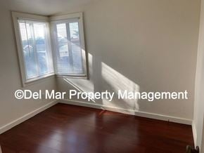 Grover Beach apartment for rent - A room with a wooden floor and a window with blinds.