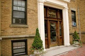 Cambridge apartment for rent - the front of a brick building with a wood door