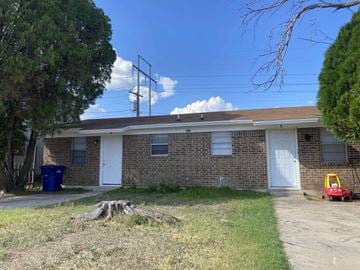 Copperas Cove apartment for rent - an old brick house with a white door and a tree