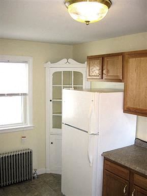 Worcester apartment for rent - a kitchen with a white refrigerator and a cabinet
