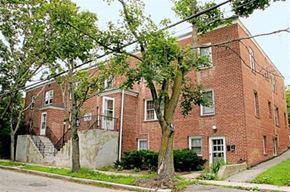 Worcester apartment for rent - a red brick building with trees in front of it