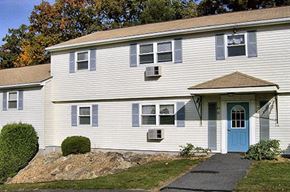 Charlton apartment for rent - a white house with a blue door and a sidewalk