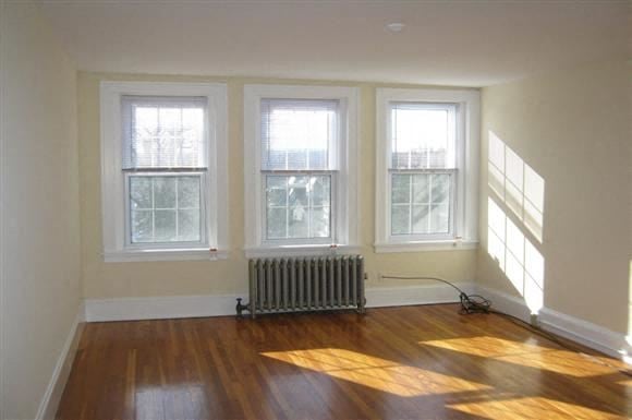 Worcester apartment for rent - a living room with a radiator and three windows