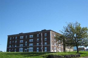 Worcester apartment for rent - a brick building on a hill with a tree