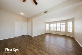 Phoenix house for rent - an empty living room with white walls and wood flooring