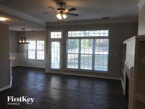 Charlotte house for rent - A room with a ceiling fan and a large window.