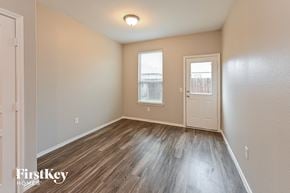 Houston house for rent - A room with wooden flooring and a window with blinds.