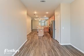 Houston house for rent - A kitchen area with wooden floors and a refrigerator.