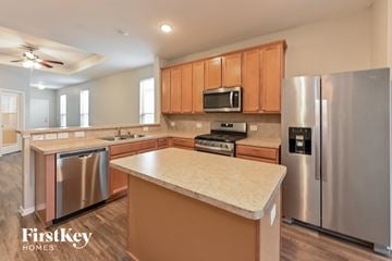 Houston house for rent - A kitchen with a stainless steel refrigerator and a countertop.