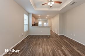 Houston house for rent - A spacious room with wooden flooring and a ceiling fan.