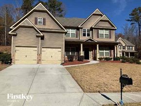 Kennesaw house for rent - a house with two garage doors on a sidewalk