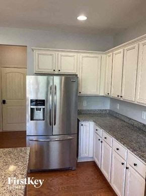 Kennesaw house for rent - a kitchen with white cabinets and a stainless steel refrigerator