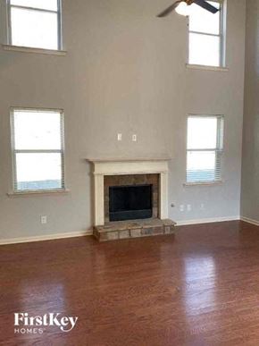 Kennesaw house for rent - a living room with a fireplace and a wooden floor