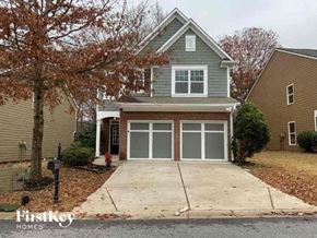 Cumming house for rent - a house with a driveway and a garage door