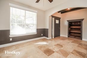 Baytown house for rent - an empty living room with a large window and a door to a staircase