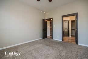 Baytown house for rent - a living room with a carpeted floor and a door to a hallway and a