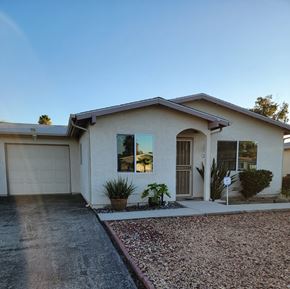 Hemet house for rent - A house with a garage and a driveway.