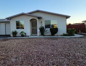 Hemet house for rent - A house with a gravel driveway in front.