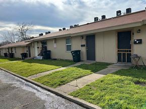 Killeen apartment for rent - the front of a white building with grass and a sidewalk