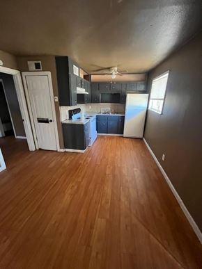 Killeen apartment for rent - an empty living room and kitchen with wood floors