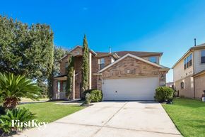 Humble house for rent - a home with a driveway and a garage door