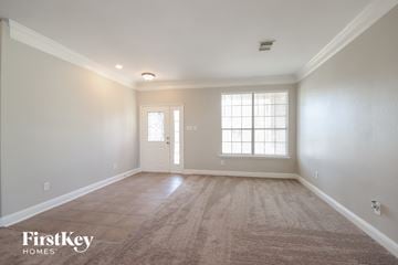 Humble house for rent - the living room of a new home with white walls and carpet