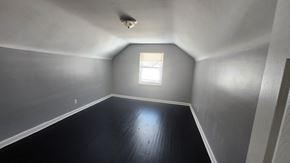 Cincinnati house for rent - A room with a window and a wooden floor.