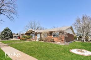 St Louis house for rent - a home with a lawn and a sidewalk in front of it
