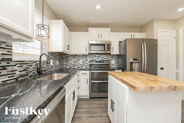Antioch house for rent - A kitchen with a wooden counter top and stainless steel appliances.