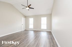 Antioch house for rent - A spacious room with a ceiling fan and wooden flooring.