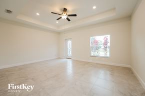 North Port house for rent - an empty living room with a ceiling fan and a window