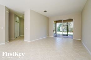 Lehigh Acres house for rent - A spacious room with a sliding glass door leading to a backyard.
