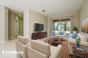 Lehigh Acres house for rent - A living room with a flat screen TV and a large window.