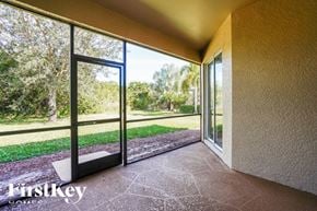 Lehigh Acres house for rent - A patio with a sliding glass door opens to a grassy area.